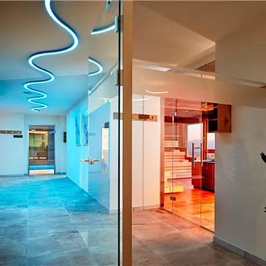A modern interior with a smooth stone floor and minimalist design. Soft LED lighting creates an inviting atmosphere.