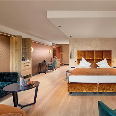 A modern hotel room with a cozy bed and stylish furniture. The room design is elegant and inviting.