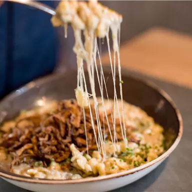 A delicious dish with melting cheese and crispy onions. The rich sauce is perfect for any gourmet.