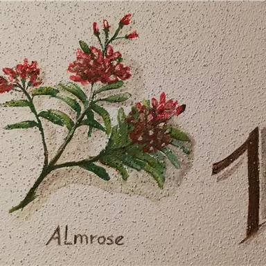A mural with red flowers and green leaves. Next to the flowers is the number one and the inscription "Almrose".