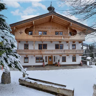 A charming, rustic building in a snow-covered setting. The facade displays traditional alpine architecture and a welcoming atmosphere.