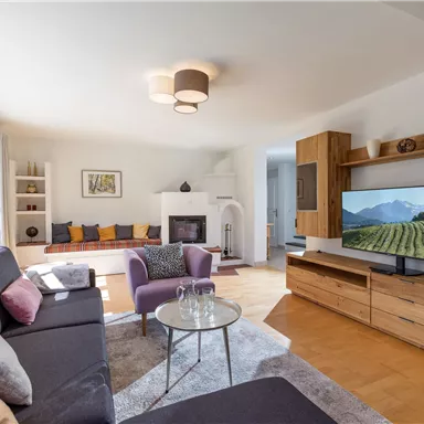 A cozy living room with a modern sofa and a television.
Large windows let in plenty of light and create an inviting atmosphere.