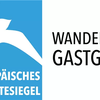 A logo with a stylized bird on a blue background. Below it says "European Hiking Quality Seal" and on the right "Hiking-Affine Host".