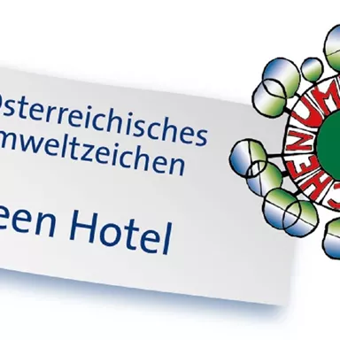 A logo for the Austrian Environmental Seal with the text "Green Hotel". It symbolizes eco-friendly practices in the hotel industry.