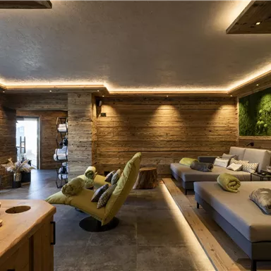 A cozy wellness area with modern loungers and warm wooden design. Soft lighting creates a relaxing atmosphere.