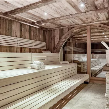 A cozy sauna area with wooden paneling and benches. The room exudes a relaxing atmosphere.