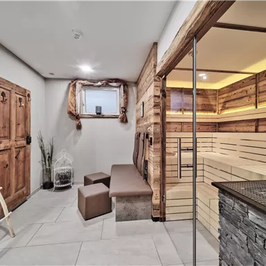 A cozy wellness area with wooden paneling and a sauna. The room offers a relaxed place to unwind and feel good.