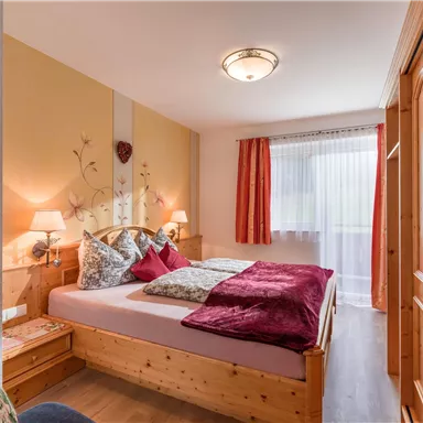 A solid wood bed made of spruce in comfort height 180x200cm with an open foot end