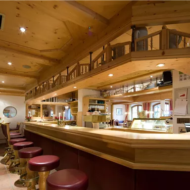 A cozy bar with wooden interiors and light wood details. The decor invites you to linger and relax.