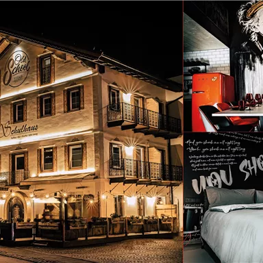 A cozy hotel with a brightly lit facade and inviting terraces. The interior features stylish furniture and modern wall art.