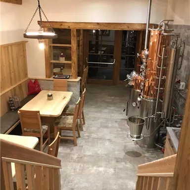 A well-equipped distillery with wood details and modern equipment. The space is bright and friendly, ideal for the production of spirits.