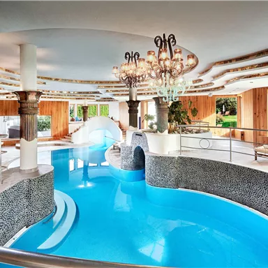 An elegant wellness area with a beautiful blue pool. Large windows allow plenty of light into the room.