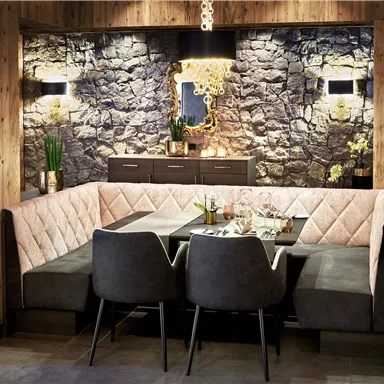 A modern restaurant with comfortable seating and elegant wooden paneling. The atmosphere is cozy and inviting.