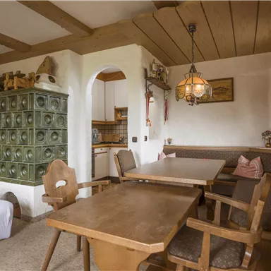 A cozy room with wooden ceilings and rustic furnishings. The table and chairs invite you to linger.
