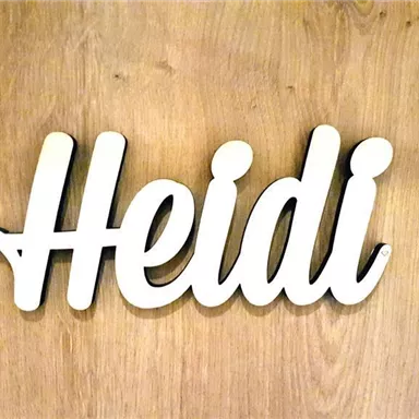 A lettering with the name "Heidi" in white color on a wooden background. The style is modern and friendly.