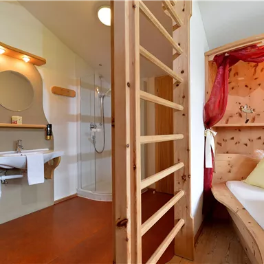 A modern room with a comfortable bed and a bright bathroom. The decor is made of wood and provides a cozy atmosphere.