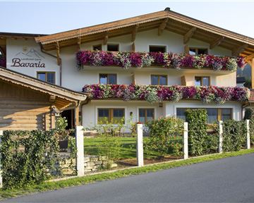A charming hotel with blooming balcony boxes. Surrounded by green countryside and a well-maintained garden.